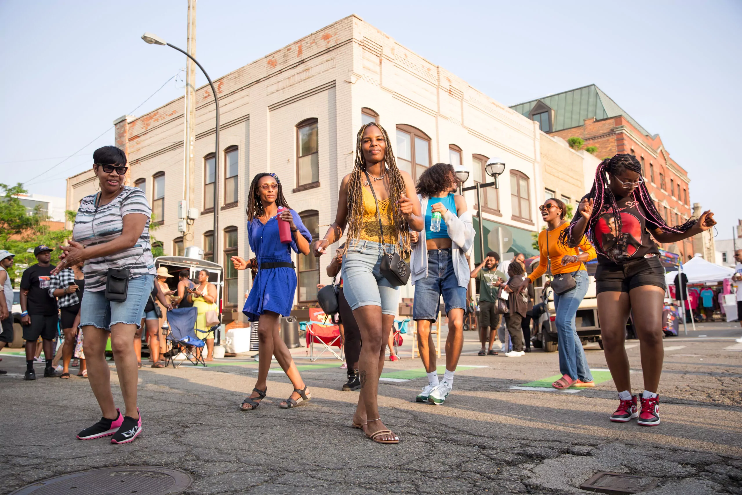 A group of diverse women celebrate African American Festival in the streets of Downtown Ann Arbor