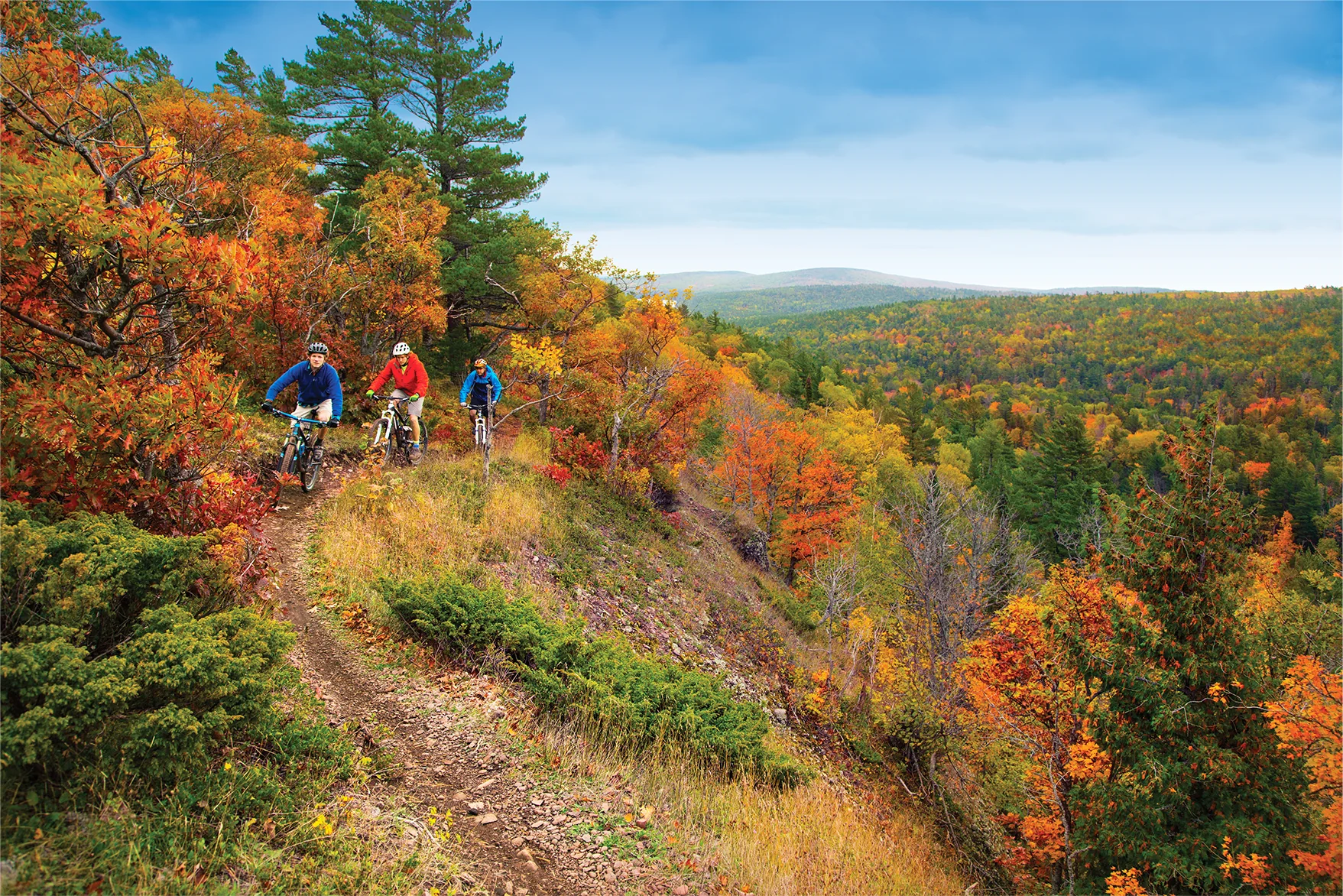 biking across a gorgeous fall backdrop in Michigan