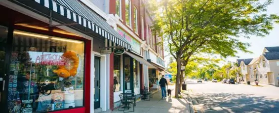 Small business store fronts line a downtown street