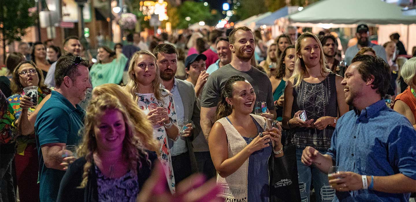 Crowd gathers outside in summer in downtown Traverse City