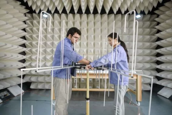 Female and male engineer work in laboratory testing space.