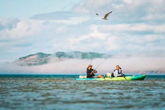 Couple fishes while kayaking on Lake Michigan.